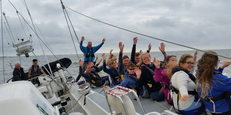 Young people sailing and waving onboard Challenge Wales Tall Ship